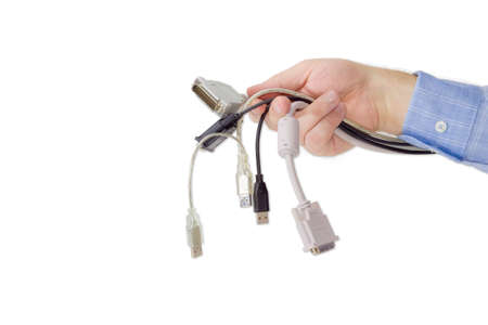 Several various cables with connectors for computers technology in a man's hand on a light backgroundの写真素材