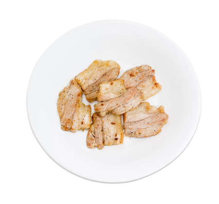 Several slices of fried pork on white dish on a light background closeupの写真素材