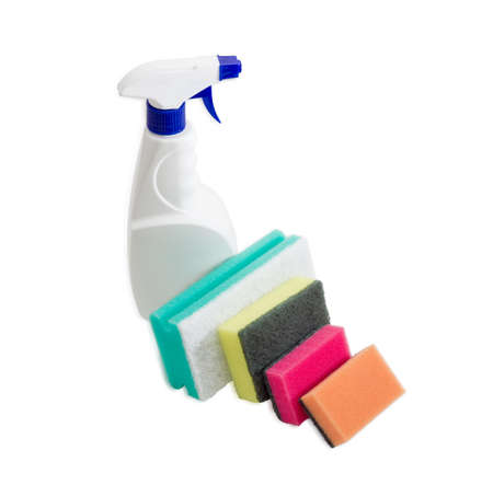 Several synthetic cleaning sponges with layer for more intense scrubbing different colors and sizes and plastic spray bottle of cleaning agent on a light backgroundの写真素材