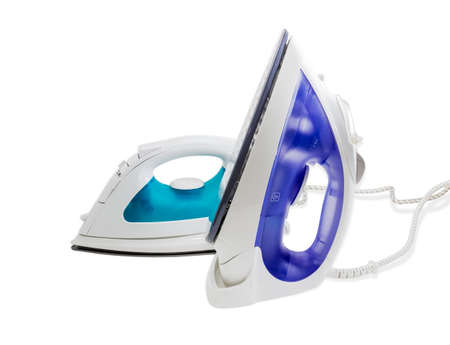 Two modern electric steam iron on a light background. Isolation.の写真素材