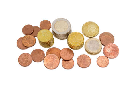 Several euro coins from 1 to 50 cents, and in denominations of 1 and 2 euro partly stacked and partly scattered on a light backgroundの写真素材