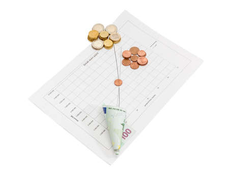 Euro coins different denominations and one banknote on the line chart of income and cost of sales Vs time on a light backgroundの写真素材