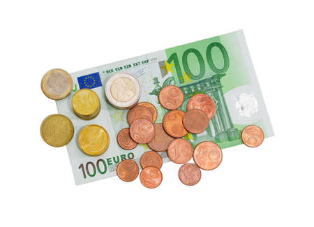 Several euro coins from 1 to 50 cents and in denominations of 1 and 2 euro on the background of banknote in denomination of 100 euro on a light backgroundの写真素材