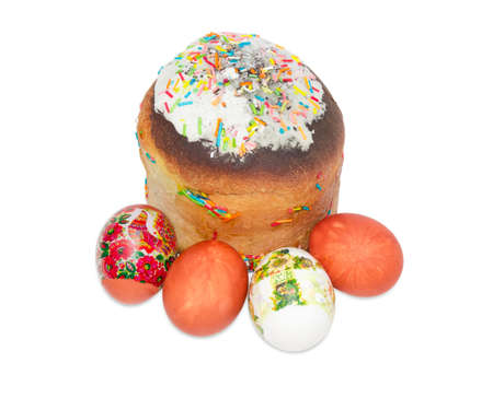 Easter cake decorated with white icing and colorful sugar decors and several Easter eggs with a...