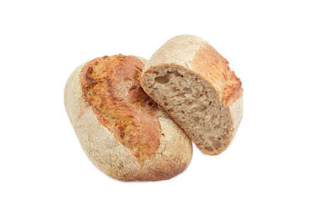 One whole loaf and one half loaf of wheat unleavened bread with bran on a light backgroundの写真素材