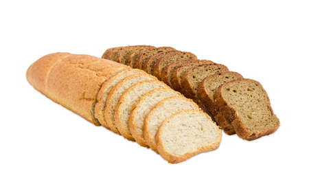 One partly sliced long loaf of wheat bread with bran and sliced brown bread with whole grain on a light backgroundの写真素材