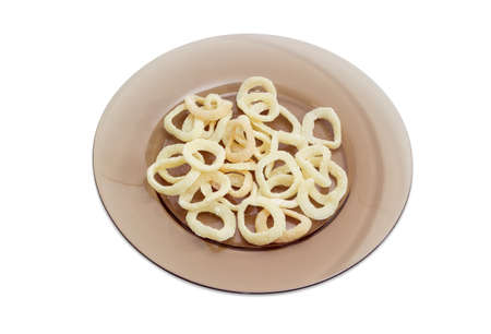 Potato chips with appearance of a fried squid rings and taste of a calamari on dark glass dish on a light backgroundの写真素材