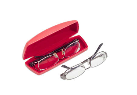 One modern pair of women's eyeglasses in open red spectacle case and one pair of eyeglasses with metal frame beside on a light backgroundの写真素材