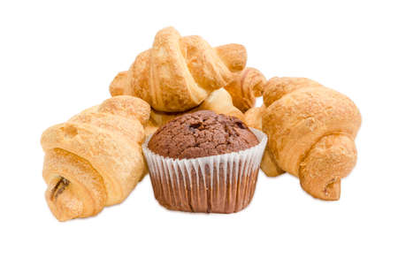Several small croissant and sweet chocolate muffin in a paper cup on a light backgroundの写真素材