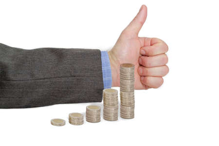 Diagram, built of euro coins on the background of male hand with approving gesture with a raised thumb up on a light backgroundの写真素材