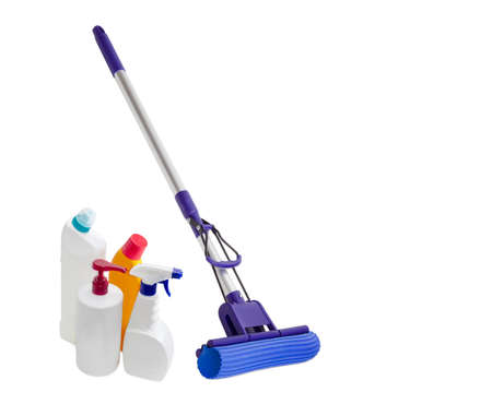 Blue plastic mop with aluminium handle, mounting clamp and a sponge and several different bottles of cleaning agents on a light backgroundの写真素材