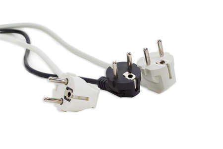 White, black and gray power plugs standards of continental Europe with mains cables on a light backgroundの写真素材