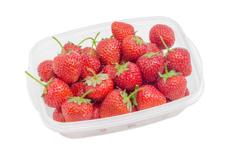 Ripe fresh garden strawberry fruits in the plastic tray on light backgroundの写真素材