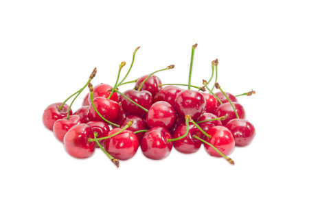 Pile of a ripe dark red sweet cherries with  the stalks and water drops of  on a light backgroundの写真素材