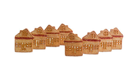 Cookies in the form of houses chalets with inserts of red gelatin on light backgroundの写真素材