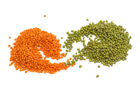 Orange and green lentils without husk on a light backgroundの写真素材