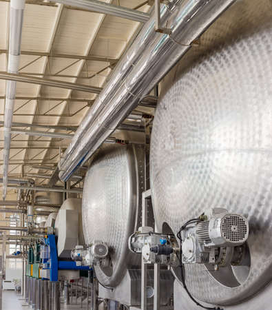 Stainless steel vessels and other equipment in workshop of primary grapes processing and primary...