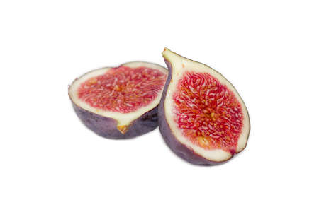 Fresh ripe fig fruit, cut in half closeup on a light background