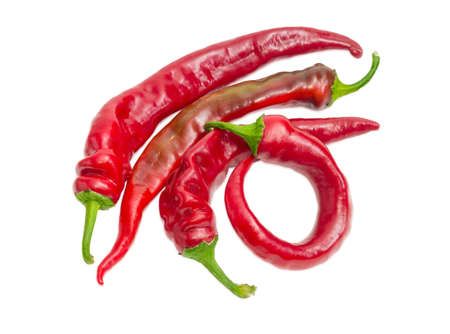 Several fresh red peppers chili on a light backgroundの写真素材