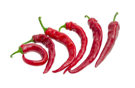 Several fresh red peppers chili  with different form of pods on a light backgroundの写真素材