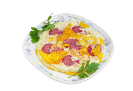 Omelette with sausage and twigs of parsley on a dish on a light backgroundの写真素材