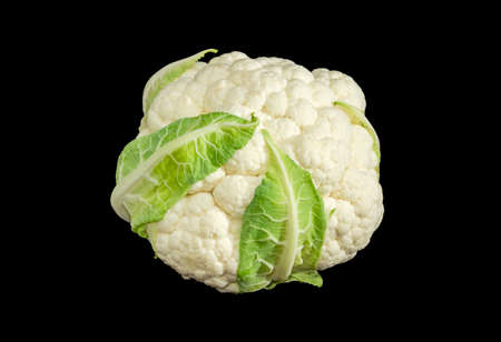 Head of ripe white cauliflower with a few leaves on a dark backgroundの写真素材