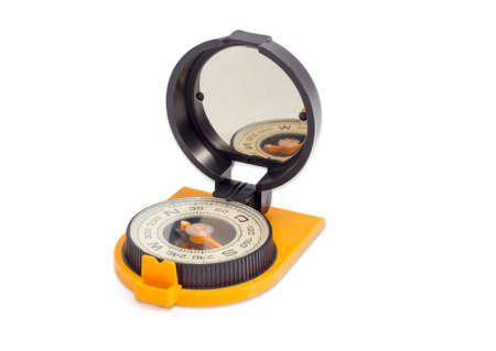 Dry magnetic tourist compass with mirror of sighting mechanisms on a light backgroundの写真素材
