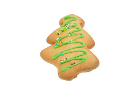 Christmas decorated cookie in the form of Christmas tree on a light backgroundの写真素材