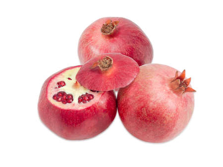 Two whole fresh pomegranates and one partly cut pomegranate on a light backgroundの写真素材