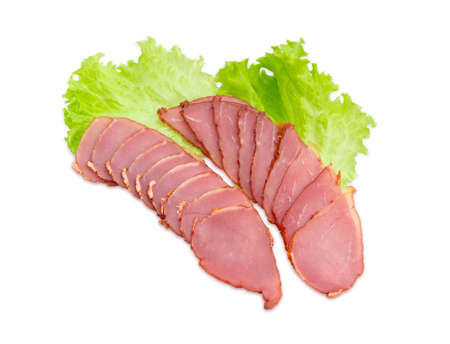 Sliced cured pork tenderloin on a lettuce leaves on a light backgroundの写真素材