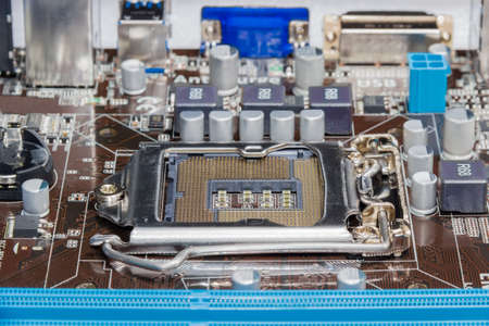 Fragment of motherboard of a desktop computer with the central processing unit socket in center...