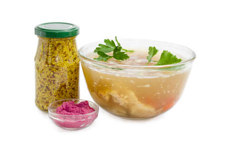 Pork aspic in transparent glass bowl, beet horseradish sauce in small glass, French mustard in small glass jar on a light backgroundの写真素材