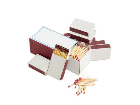 Household safety matches made from wood in one large and several small cardboard matchboxes and beside separately without box on a light backgroundの写真素材