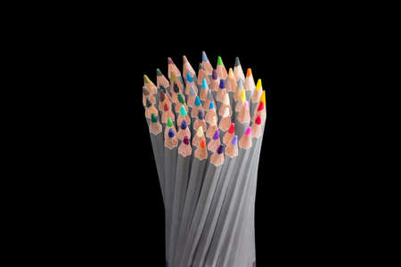 Bunch of colored pencils in gray wooden case on a dark backgroundの写真素材