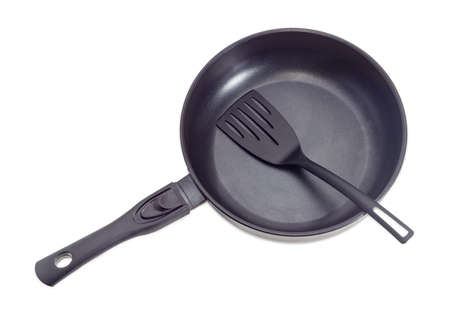 Cast frying pan, made of aluminium alloy with removable handle and plastic spatula on a light background
の写真素材