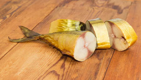 Tail portions and several other pieces of a cold-smoked Atlantic mackerel on a surface of an old wooden planks
の写真素材