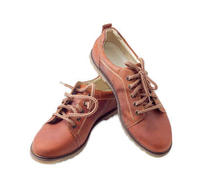 Pair of new leather brown mens shoes  with a shoelaces on a light backgroundの写真素材