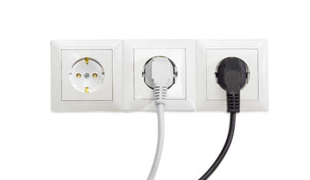 Three white socket outlets with two connected corresponding power plugsの写真素材