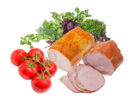 Partly sliced smoked cooked ham with pork loin and piece ham with turkeys, cluster of tomatoes against the background of a bunch of the cilantro, parsley and basil on a light backgroundの写真素材