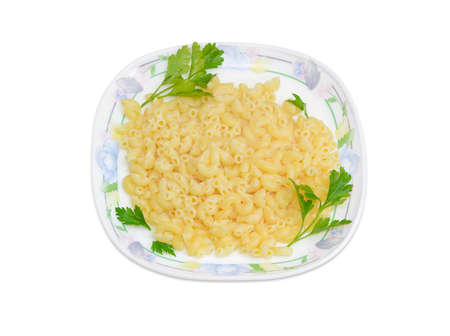 Cooked short curved macaroni decorated with a small parsley twigs on a dish on a light background
の写真素材