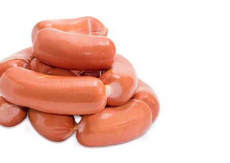 Pile of the uncooked thick wieners in the natural casing bound by twine closeup on a light backgroundの写真素材
