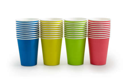 Row of the piles of the disposable paper cups in red, green, blue and yellow colors on a light backgroundの写真素材