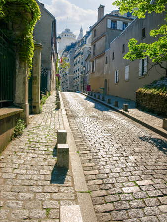 Old street covered with paving stones on the Montmartre hill in Paris, Franceの写真素材