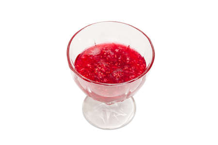 Raspberry jam in the glass dessert stem bowl on a light backgroundの写真素材