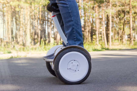 Legs of young man riding a self-balancing scooterの写真素材