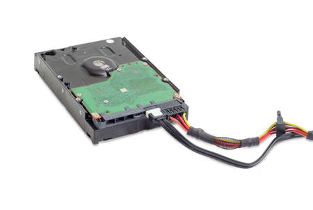 Hard disk drive for use in desktop computers with connected power cable and data cable on a white...