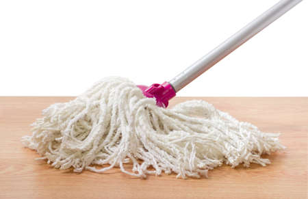 Classic mop with cotton head and metal tubular handle on a wooden floor on a white backgroundの写真素材