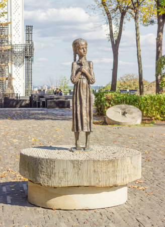 Kiev, Ukraine, October 08, 2015: Sculpture of young girl with wheat ears in their hands known as the "Bitter Memory of Childhood" on alley of National Museum "Memorial to Holodomor victims"のeditorial素材