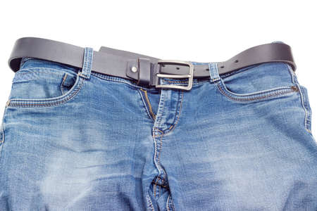 Casual black belt for men, made of thick leather with classical buckle passed through the belt loops of the blue jeans on a white backgroundの写真素材