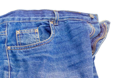 Fragment of the top of the used classical blue jeans on a white background